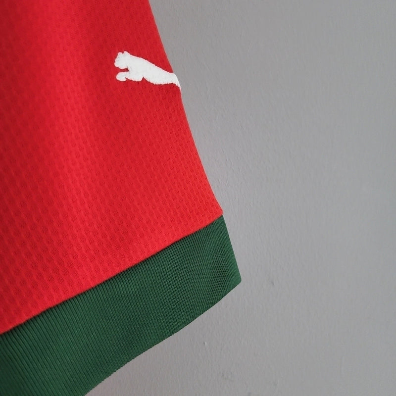 Camisa Marrocos 2022/23 Home I Torcedor Masculina - modelo vermelho, uniforme principal da seleção marroquina, escudo em destaque e design clássico para os torcedores.