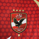 Camisa Al-Ahly Home I 2024/25 Adidas Torcedor Masculina - modelo vermelho, uniforme principal do clube egípcio, escudo em destaque e design moderno assinado pela Adidas.