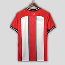 Camisa Sheffield United Home I 2023/24 Torcedor Masculina - modelo vermelho com listras brancas, uniforme principal da temporada, com escudo em destaque e design tradicional que simboliza a história do clube inglês.