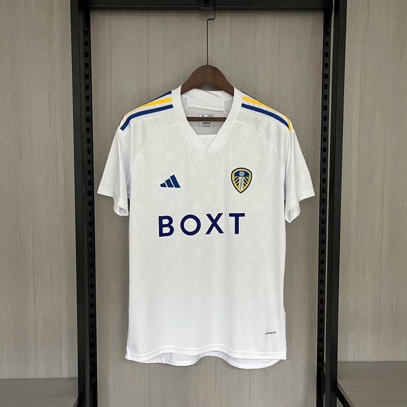 Camisa Leeds United Home I 2023/24 Torcedor Masculina - modelo branco, uniforme principal da temporada, com escudo em destaque e design clássico que reflete a tradição e o orgulho do clube inglês.