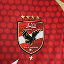 Texto alternativo (alt text):
Camisa Al-Ahly Home (1) 2024/25 Adidas Torcedor Masculina vermelha com detalhes em branco, escudo oficial bordado e tecido leve com tecnologia Aeroready para alta respirabilidade.

