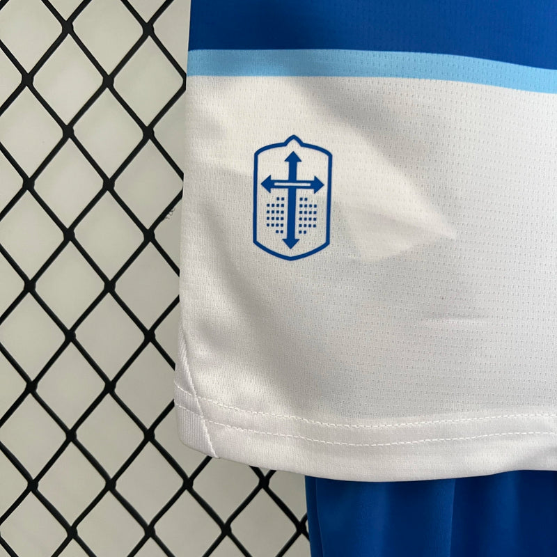 Kit Infantil Universidad Católica 2024/25 Puma – camisa azul com detalhes em branco e shorts combinando, uniforme infantil oficial da Universidad Católica, leve, respirável e confortável para crianças de 3 a 13 anos."