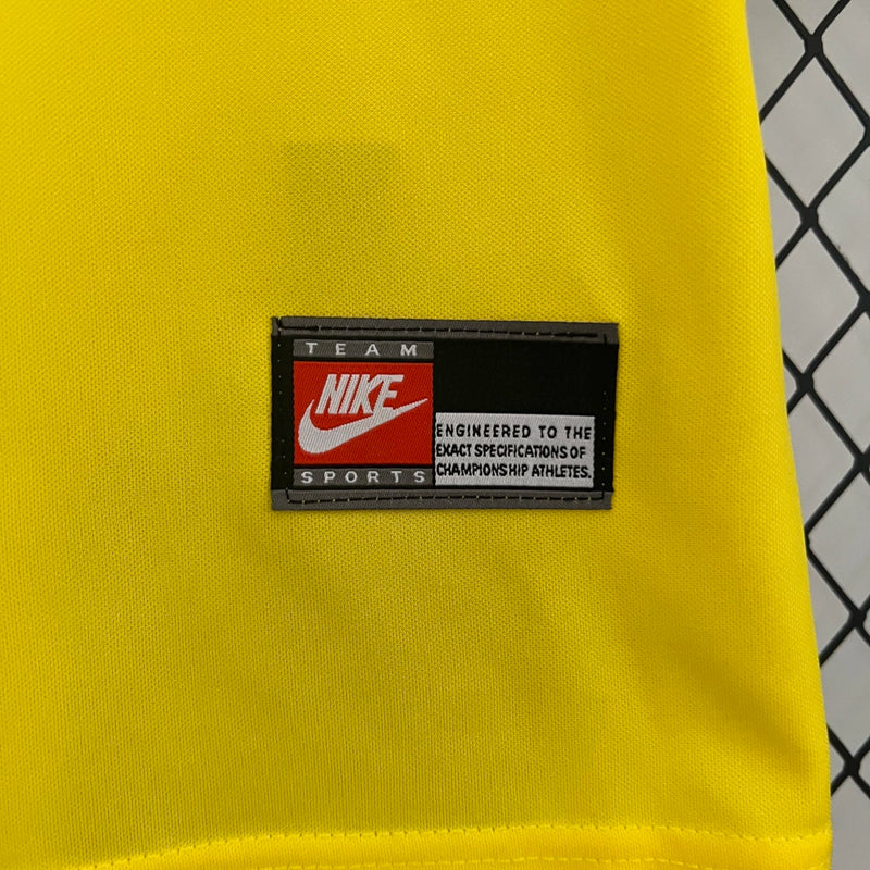 Kit Infantil Brasil Home 1998/99 Nike, camisa amarela com detalhes verdes, shorts e meias combinando, uniforme retrô oficial para crianças de 3 a 13 anos torcedoras da Seleção Brasileira."