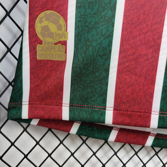 Camisa Fluminense Home 2024/25 Torcedora Feminina oficial com listras verde, grená e branco, escudo bordado, modelo moderno e confortável