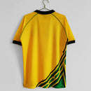 Camisa Jamaica Home I 1998/99 Kappa Retrô Masculina amarela – uniforme clássico da seleção jamaicana, modelo histórico da Copa do Mundo 1998 com detalhes verdes e pretos."