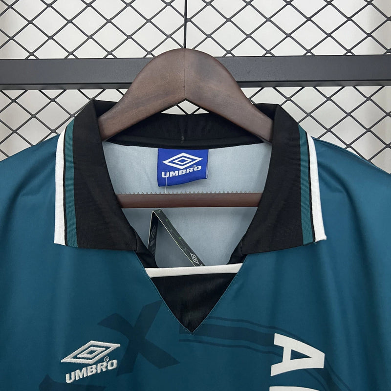 Camisa Ajax Away (2) 1995/96 Umbro Retrô Masculina azul com detalhes vermelhos e brancos, escudo clássico bordado e design vintage dos anos 90"