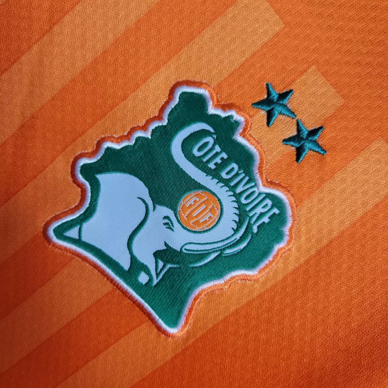 Camisa Costa do Marfim Home I 2022/23 Puma Torcedor Masculina na cor laranja – uniforme oficial dos Elefantes, modelo torcedor, tecido leve e respirável, disponível na Waze Mix."Camisa Costa do Marfim Home 2022
Camisa Costa do Marfim Puma
Camisa Costa do Marfim Laranja
Camisa Elefantes 2022/23
Camisa Costa do Marfim Torcedor Masculina
Uniforme Costa do Marfim Puma
Camisa seleção Costa do Marfim 2022
Camisa oficial Costa do Marfim