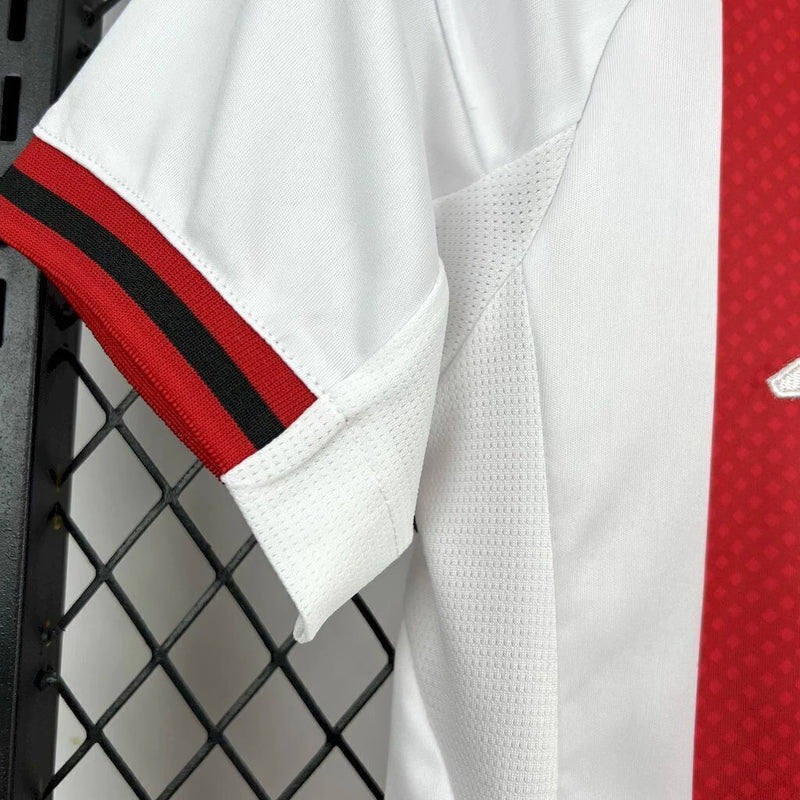 Kit Infantil Ajax Home I 2025/26 Adidas, uniforme completo com camisa e short, nas cores tradicionais do clube, ideal para treinos, jogos e momentos de lazer.