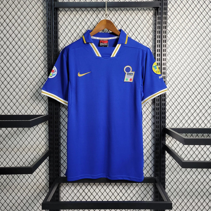 Camisa Itália Home I 1996/97 Nike Retrô masculina, azul, com escudo da seleção italiana no peito e logo Nike, feita em tecido leve e confortável, modelo retrô com caimento solto e tradicional, ideal para colecionadores e fãs de futebol histórico.”