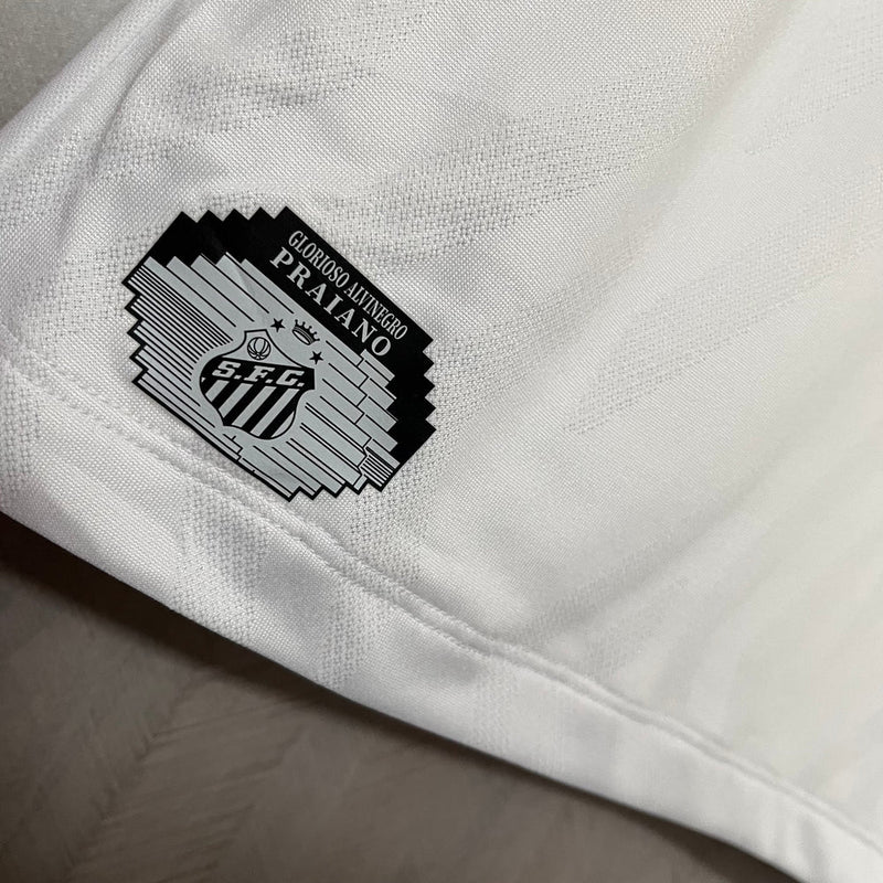 Camisa Santos Home I 2025/26 Umbro Torcedor Masculina branca, com escudo do Santos bordado no lado esquerdo do peito e logo Umbro no lado direito, modelo de jogo, versão torcedor, fundo branco.