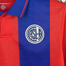 Camisa San Lorenzo Home I 2025/26 Torcedor Masculina azul com detalhes em vermelho, escudo estampado do clube argentino e tecido leve e respirável para torcedores."