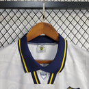Camisa Boca Juniors Away (2) 1992/96 Olan Retrô Masculina azul escura com faixa amarela horizontal, gola polo com botões e escudo bordado clássico.
