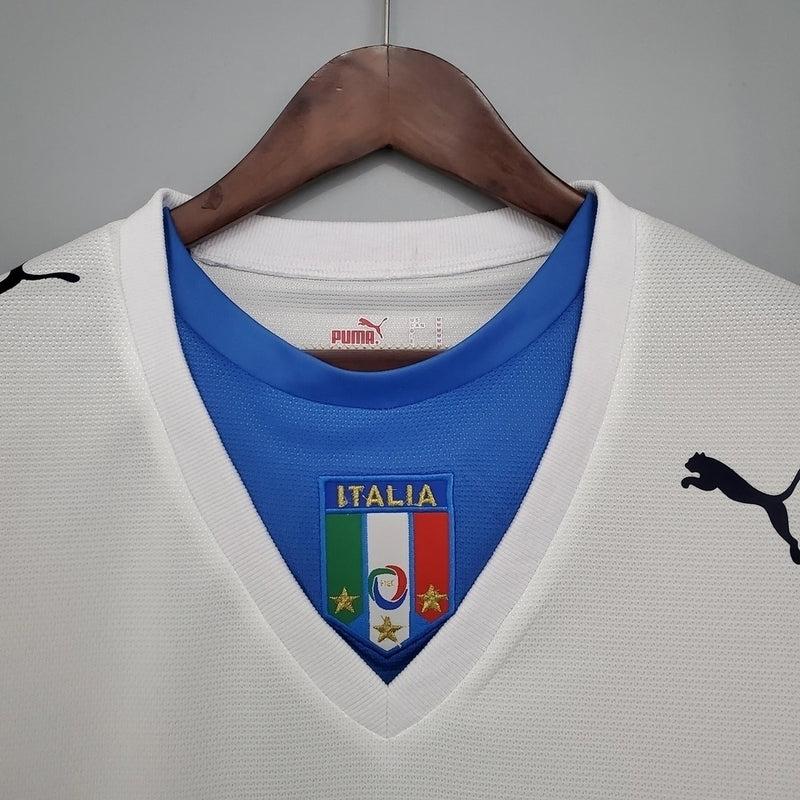 Camisa Itália Away II 2006/07 Puma Retrô masculina, branca, com escudo da seleção italiana no peito e detalhes clássicos da temporada 2006/07, feita em tecido leve e confortável, ideal para colecionadores, fãs de futebol retrô e uso casual.”