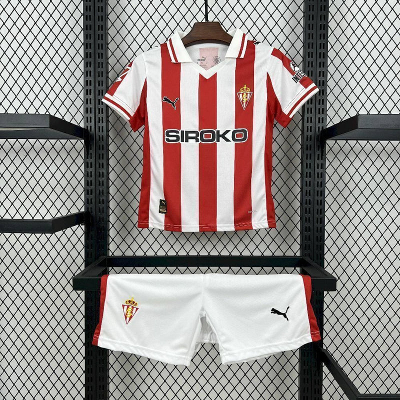 Kit Infantil Sporting Gijón Home (1) 2025/26 Puma, camisa listrada vermelha e branca com shorts oficiais, disponível dos tamanhos 3-4 anos até 12-13 anos, ideal para pequenos torcedores."