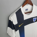 Camisa Finlândia Home I 2020/21 Nike retrô masculina branca com cruz azul e detalhes dourados, gola redonda e mangas curtas, modelo clássico em tecido leve para torcedores e colecionadores"