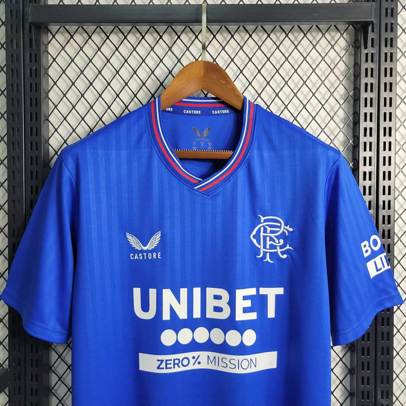 Camisa Rangers FC Home I 2023/24 Castore Torcedor Masculina Azul, uniforme moderno do clube escocês com escudo bordado e design elegante.