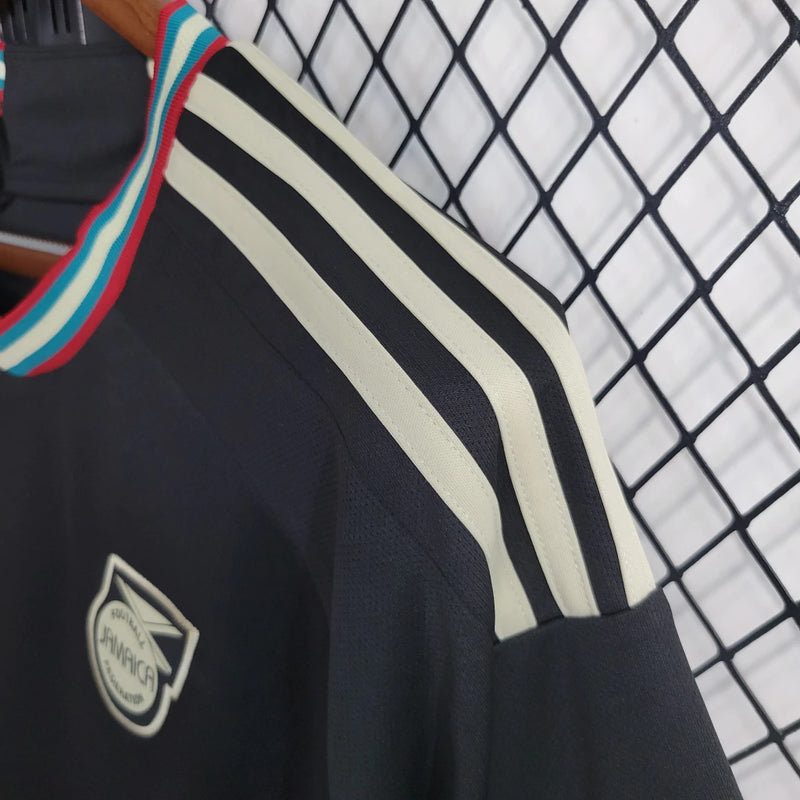 Camisa Jamaica Away II 2023/24 Adidas Torcedor Masculina preta, uniforme alternativo da seleção jamaicana, design moderno em preto com detalhes verde e amarelo, tecido leve e respirável, modelo masculino."
camisa Jamaica Away 2023/24 preta
camisa Adidas Jamaica torcedor masculina
uniforme alternativo seleção Jamaica
camisa Reggae Boyz 2023/24