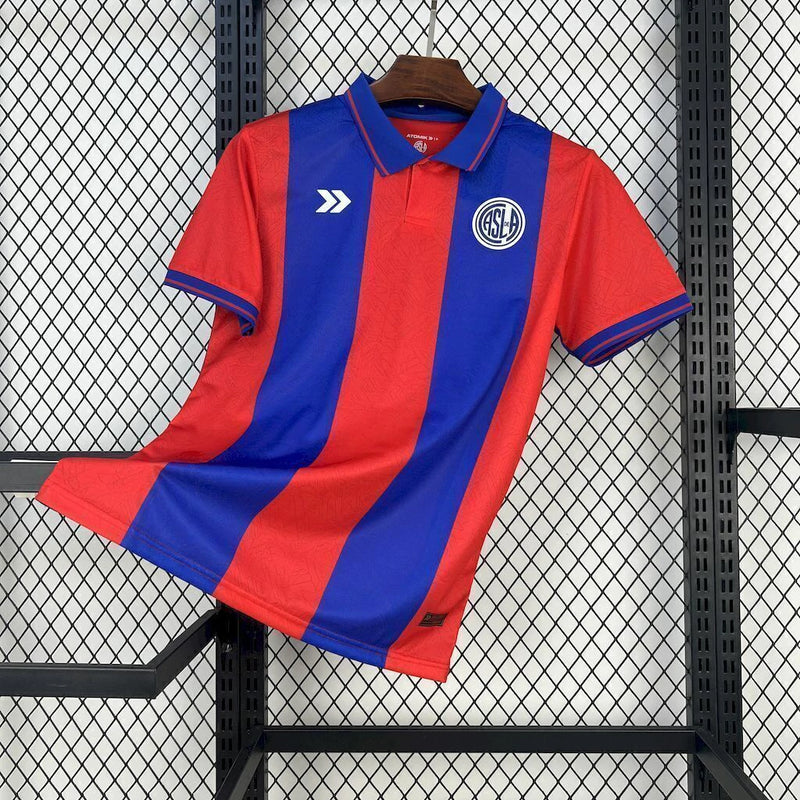 Camisa San Lorenzo Home I 2025/26 Torcedor Masculina azul com detalhes em vermelho, escudo estampado do clube argentino e tecido leve e respirável para torcedores."