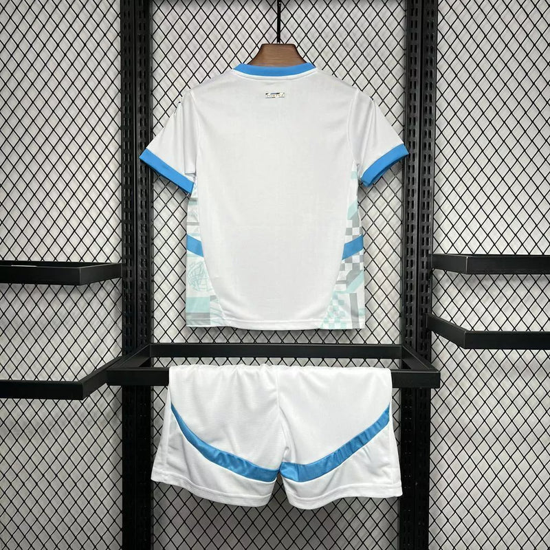 Kit Infantil Olympique de Marseille Home 2024/25 Puma – Camisa e shorts oficiais para crianças, uniforme branco com detalhes azuis e escudo do OM, tecido leve e confortável.