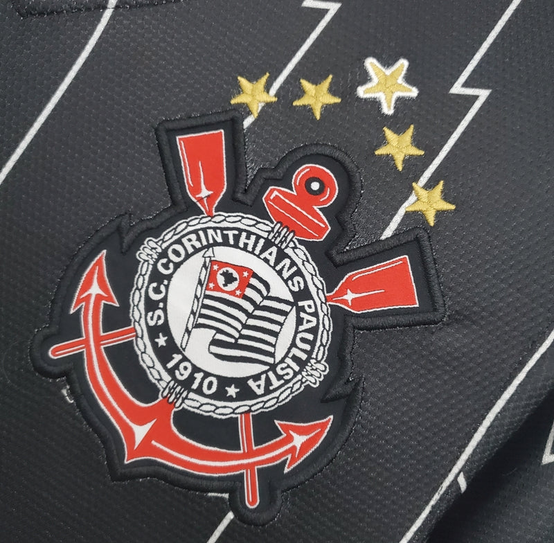 Camisa retrô do Corinthians modelo Away 2011/12 para torcedor masculino, preta com listras verticais cinza, escudo do clube bordado no peito esquerdo, logo Nike branco no peito direito e gola em V."