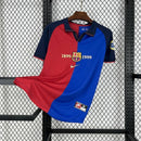 "Camisa Barcelona Home I 1999/00 Nike Torcedor Masculina edição 100 anos, uniforme retrô azul e grená com escudo comemorativo do centenário."