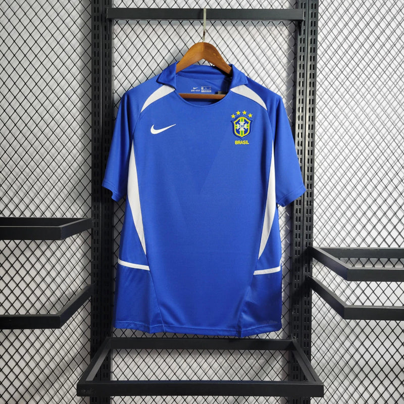 Camisa Brasil Away II 2002 Nike Retrô Masculina azul com detalhes em amarelo e verde, escudo da CBF bordado e gola careca clássica