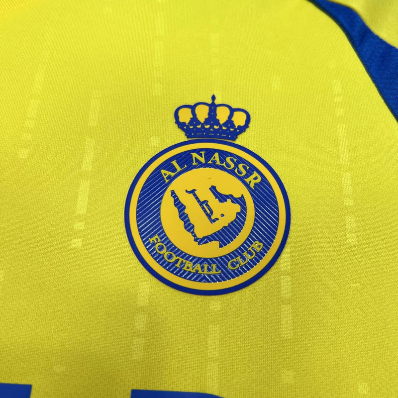 Camisa Al-Nassr Home (1) 2024/25 Adidas Torcedor Masculina na cor amarela com detalhes em azul, escudo do Al-Nassr aplicado no peito e logo Adidas bordado, modelo oficial da temporada 2024/25."
