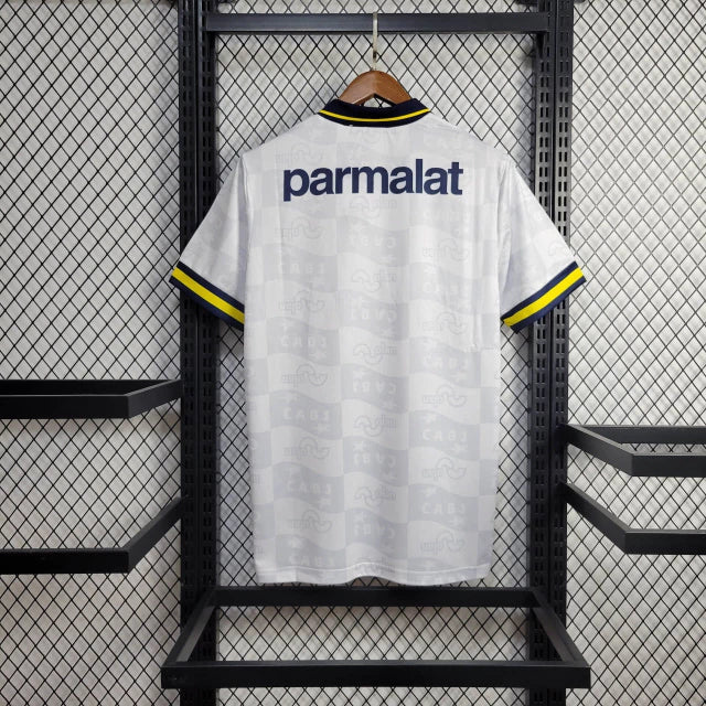 Camisa Boca Juniors Away (2) 1992/96 Olan Retrô Masculina azul escura com faixa amarela horizontal, gola polo com botões e escudo bordado clássico.
