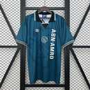 Camisa Ajax Away (2) 1995/96 Umbro Retrô Masculina azul com detalhes vermelhos e brancos, escudo clássico bordado e design vintage dos anos 90"