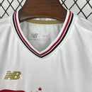 Kit Infantil São Paulo Home 2025/26 New Balance com camisa branca e faixas vermelha e preta, escudo do SPFC bordado, shorts combinando, modelo torcedor infantil, ideal para jogos, treinos e uso casual, oficial e autêntico."